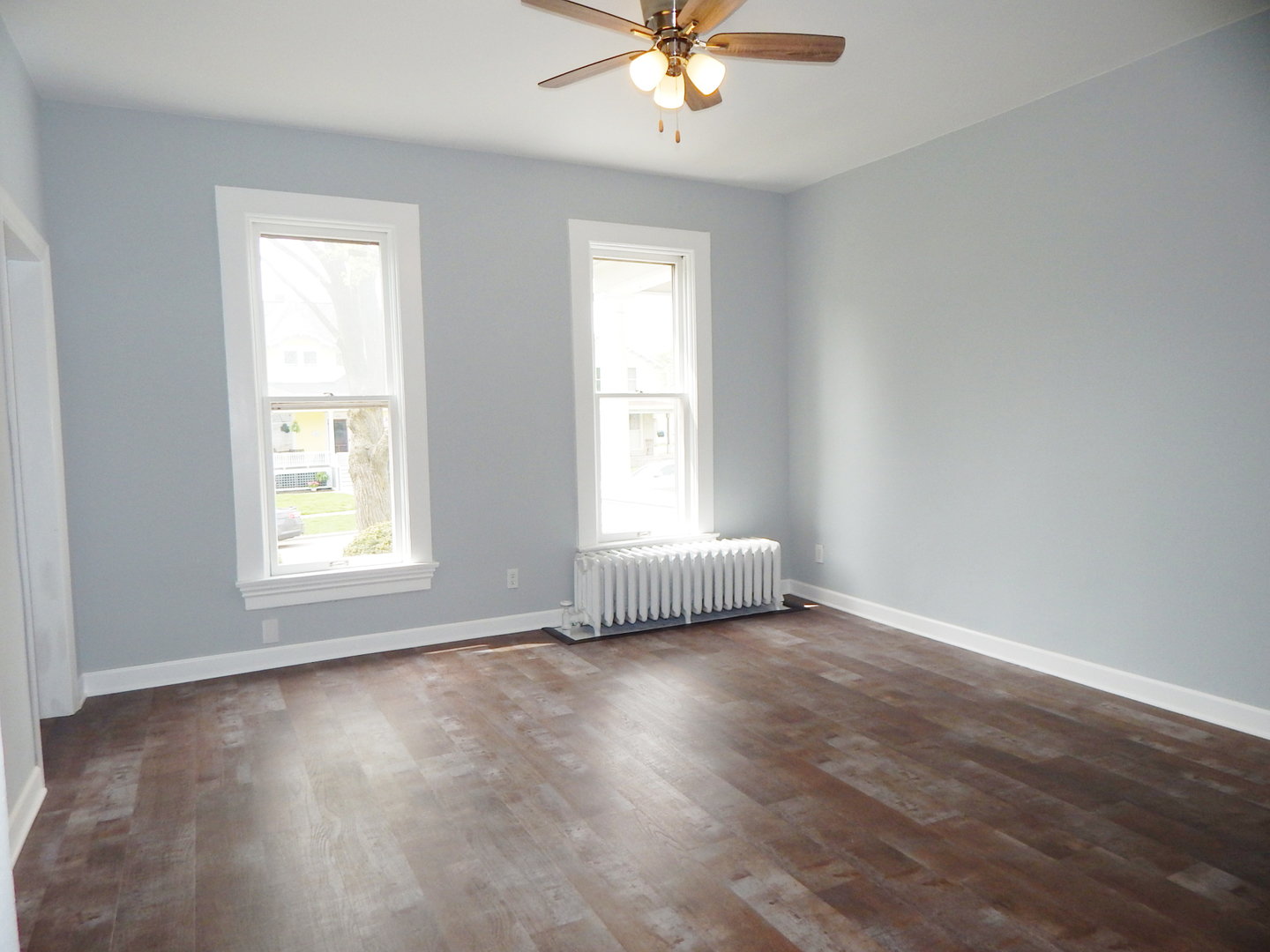 415 North Spring Street Elgin, IL 60120 - Photo 6 of 22 a view of an empty room with wooden floor and a window