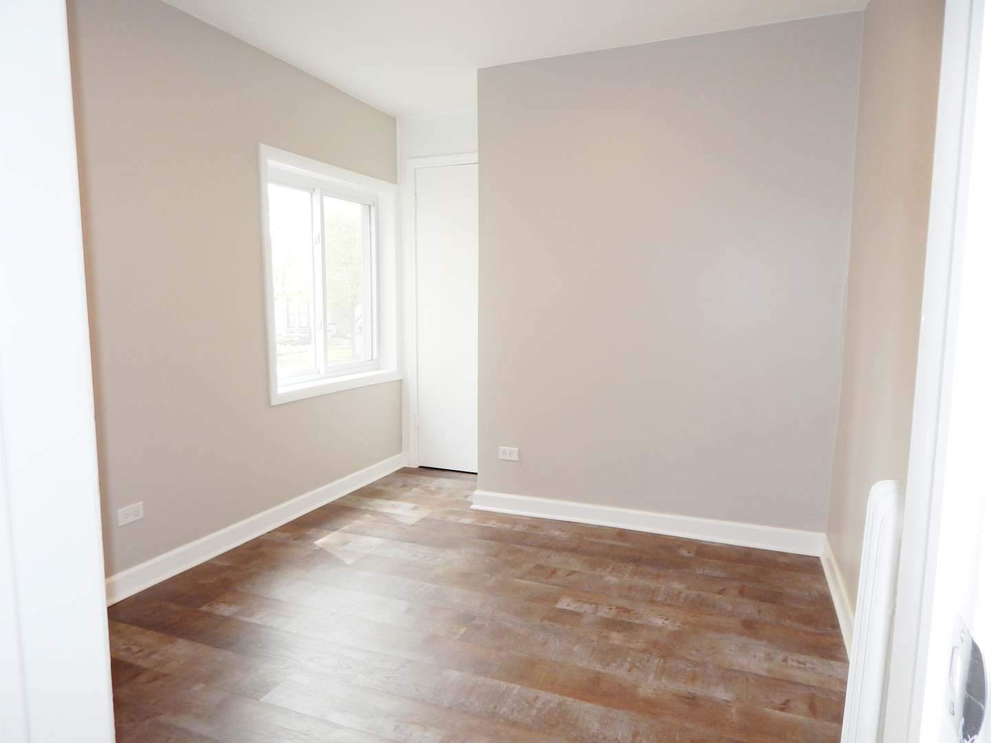 415 North Spring Street Elgin, IL 60120 - Photo 8 of 22 an empty room with wooden floor and windows