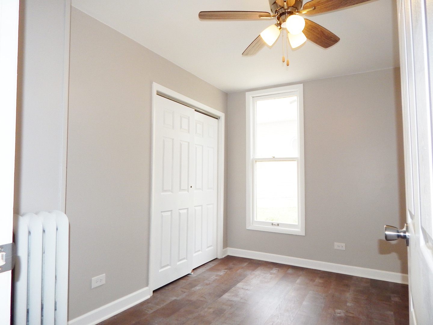 415 North Spring Street Elgin, IL 60120 - Photo 9 of 22 a view of an empty room with wooden floor and window