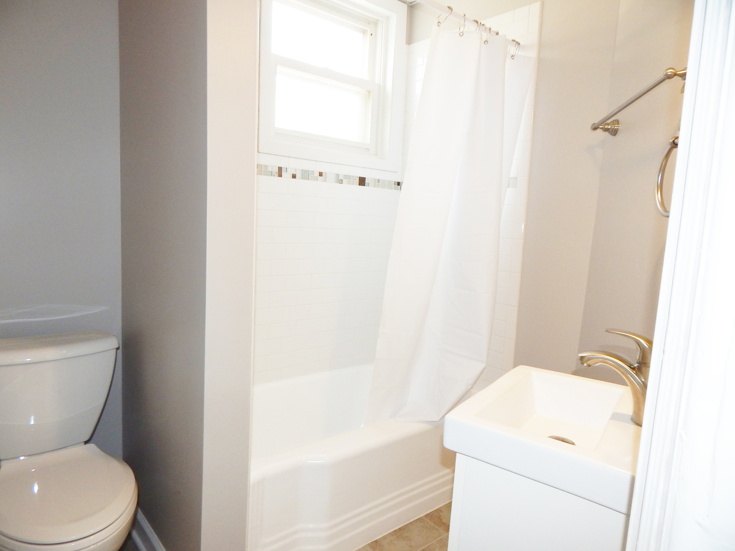 415 North Spring Street Elgin, IL 60120 - Photo 10 of 22 a white toilet sitting next to a white sink