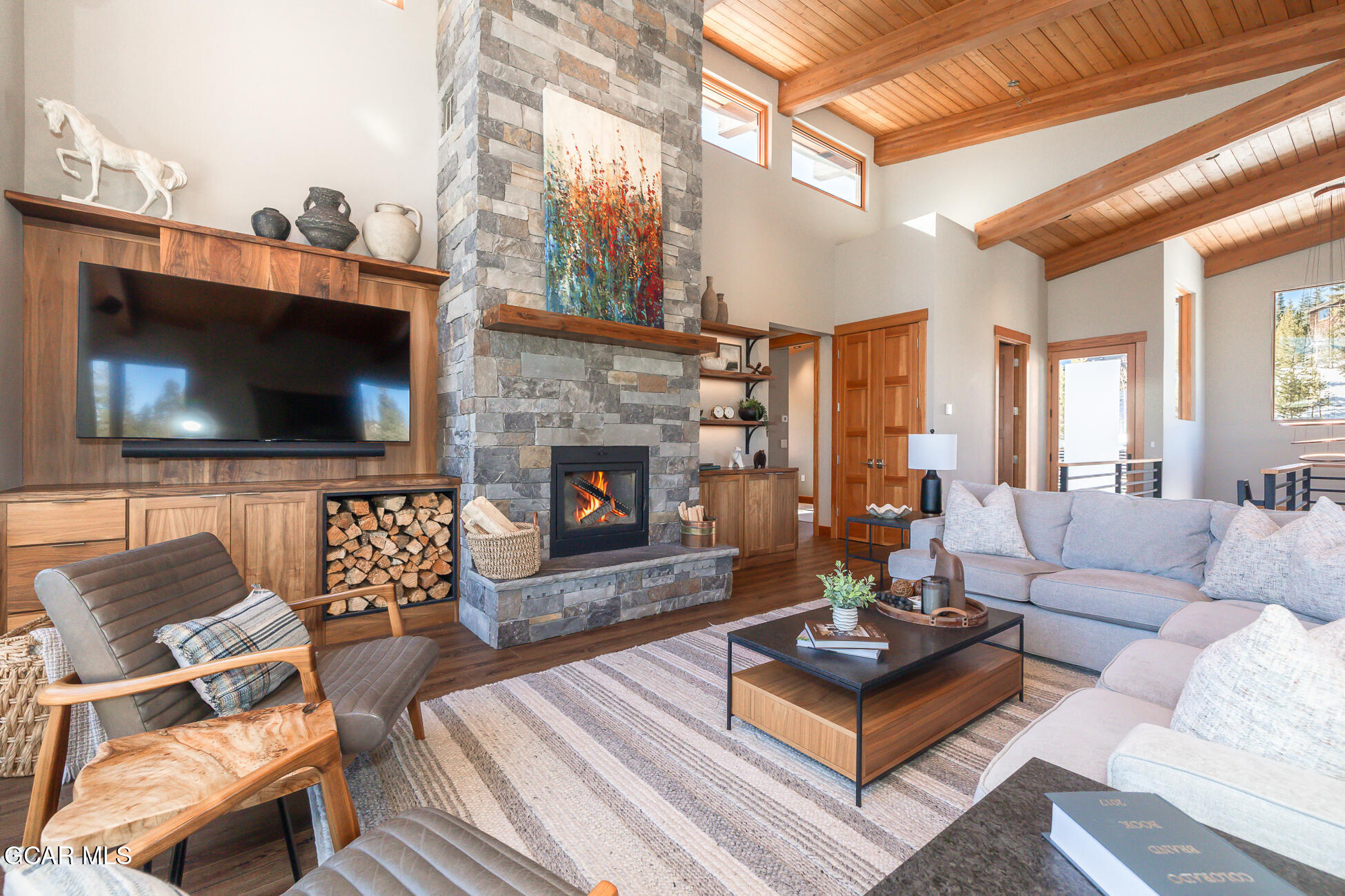 684 Vasquez Road Winter Park, CO 80482 - Photo 6 of 45 a living room with furniture a flat screen tv and a fireplace