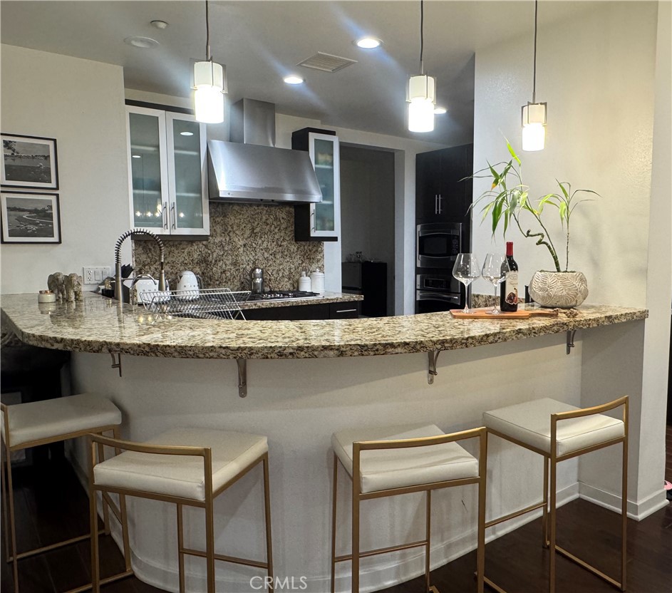 21 Gramercy, Unit 218 Irvine, CA 92612 - Photo 11 of 40 a kitchen with a table chairs sink and cabinets