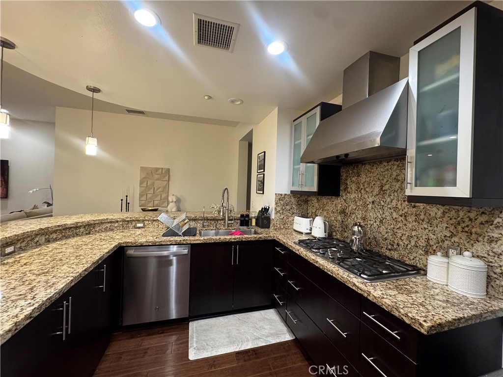 21 Gramercy, Unit 218 Irvine, CA 92612 - Photo 13 of 40 a kitchen with a sink stove and cabinets