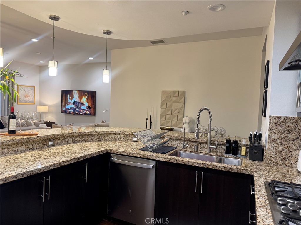 21 Gramercy, Unit 218 Irvine, CA 92612 - Photo 14 of 40 a kitchen with a sink and a refrigerator