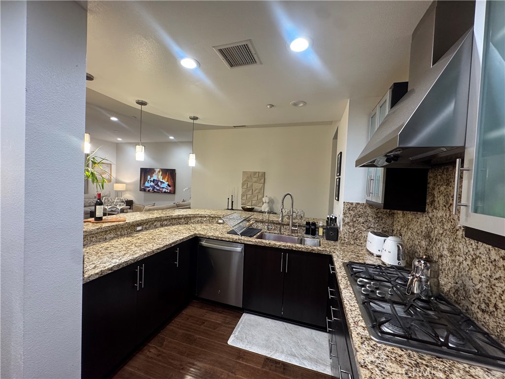 21 Gramercy, Unit 218 Irvine, CA 92612 - Photo 15 of 40 a kitchen with a sink and a stove top oven