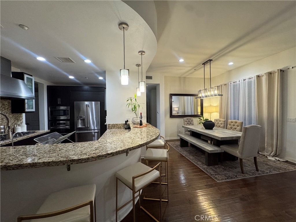 21 Gramercy, Unit 218 Irvine, CA 92612 - Photo 17 of 40 a kitchen with stainless steel appliances granite countertop counter space a sink stove and refrigerator