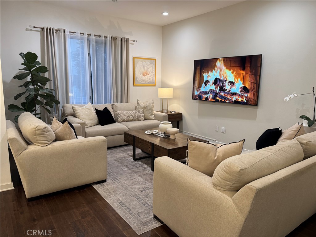 21 Gramercy, Unit 218 Irvine, CA 92612 - Photo 18 of 40 a living room with furniture a flat screen tv and a potted plant