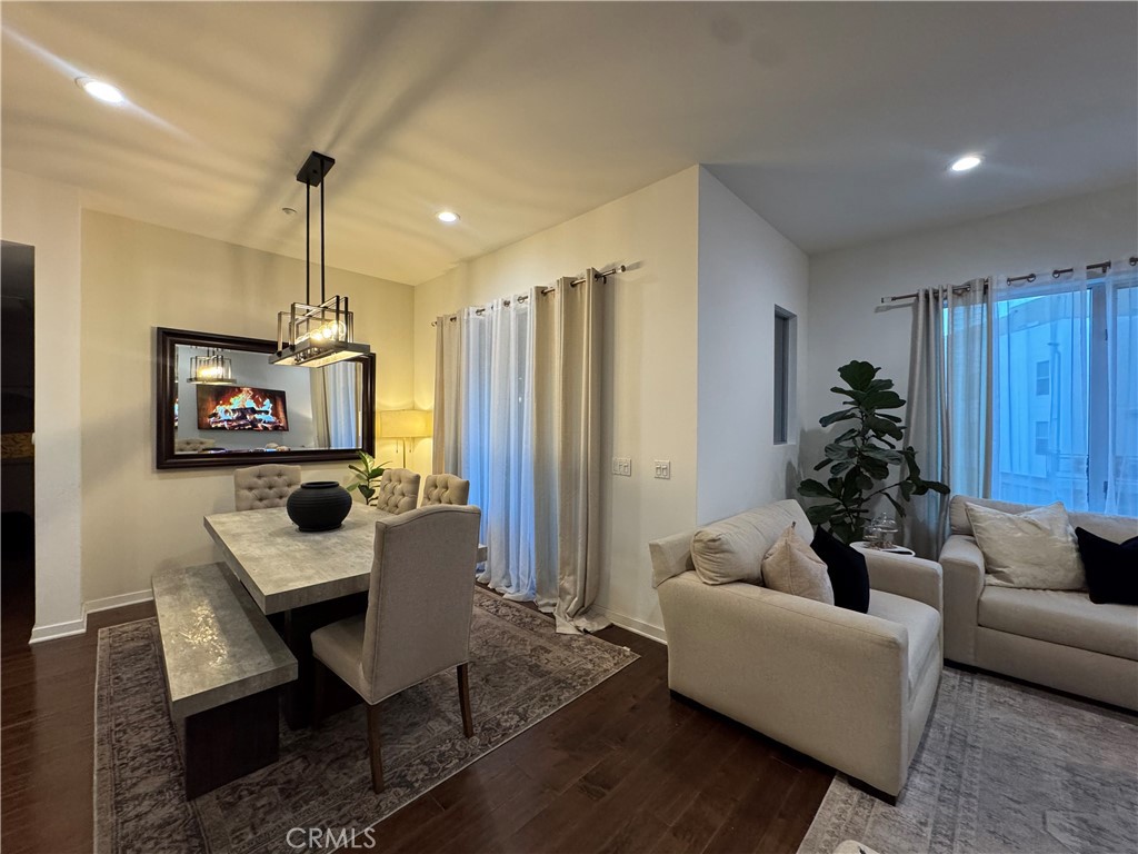 21 Gramercy, Unit 218 Irvine, CA 92612 - Photo 23 of 40 a living room with furniture and a wooden floor