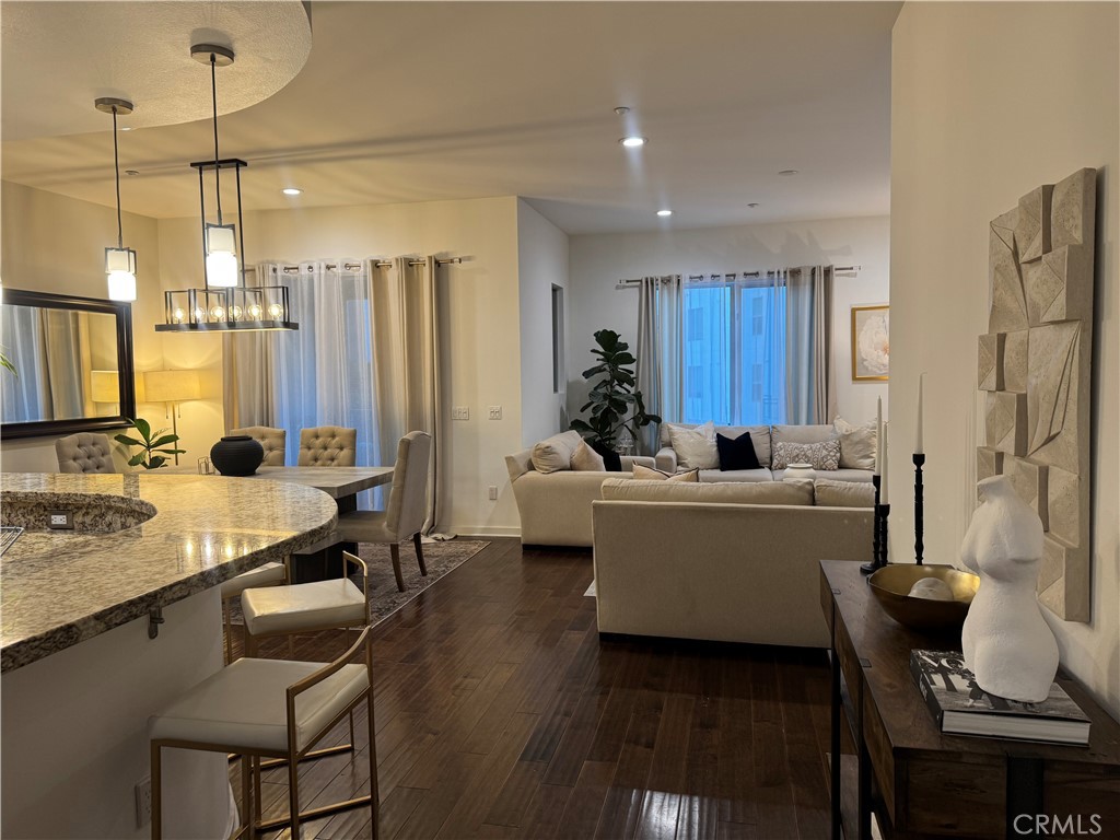 21 Gramercy, Unit 218 Irvine, CA 92612 - Photo 25 of 40 a living room with furniture and a chandelier