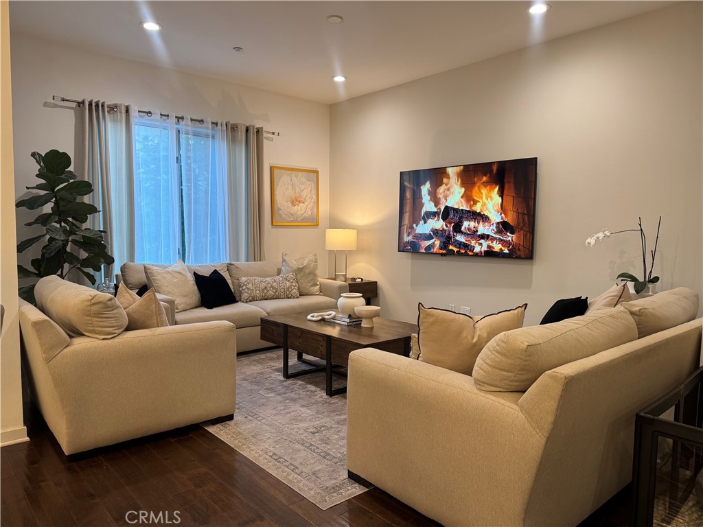 21 Gramercy, Unit 218 Irvine, CA 92612 - Photo 26 of 40 a living room with furniture and a flat screen tv