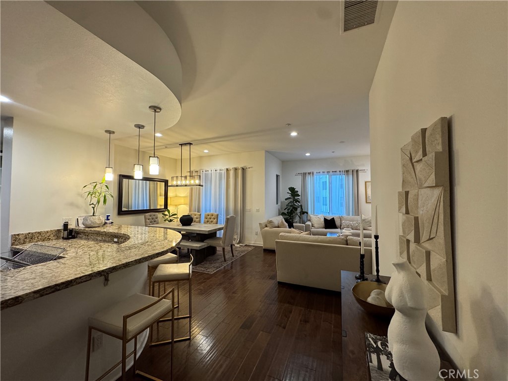 21 Gramercy, Unit 218 Irvine, CA 92612 - Photo 27 of 40 a living room with a couch and a dining table