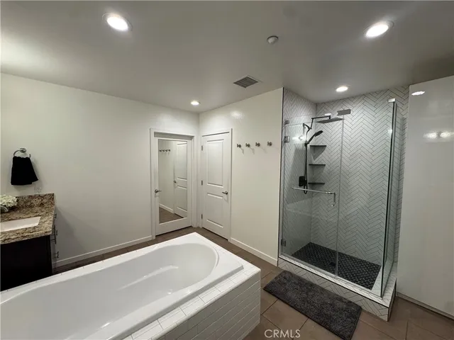 a bathroom with a granite countertop toilet sink and mirror