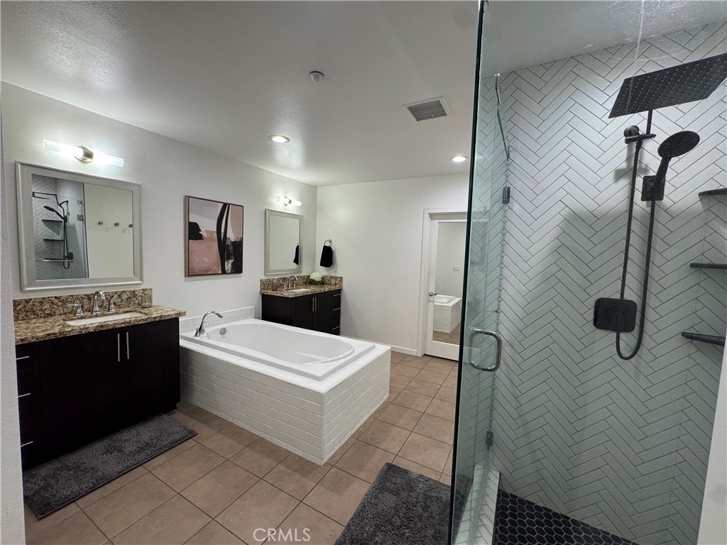 21 Gramercy, Unit 218 Irvine, CA 92612 - Photo 33 of 40 a large bathroom with a tub sink shower and mirror