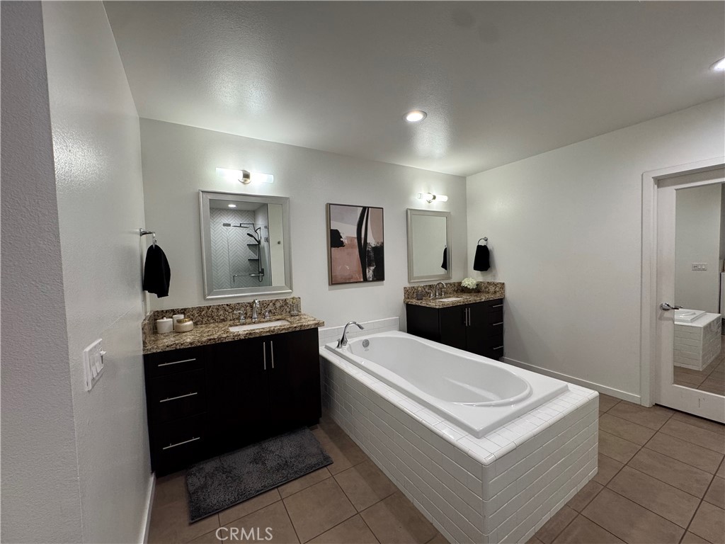 21 Gramercy, Unit 218 Irvine, CA 92612 - Photo 34 of 40 a spacious bathroom with a sink a mirror and a bathtub