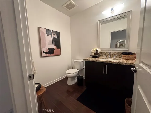 a view of a room that has a door and wooden floor