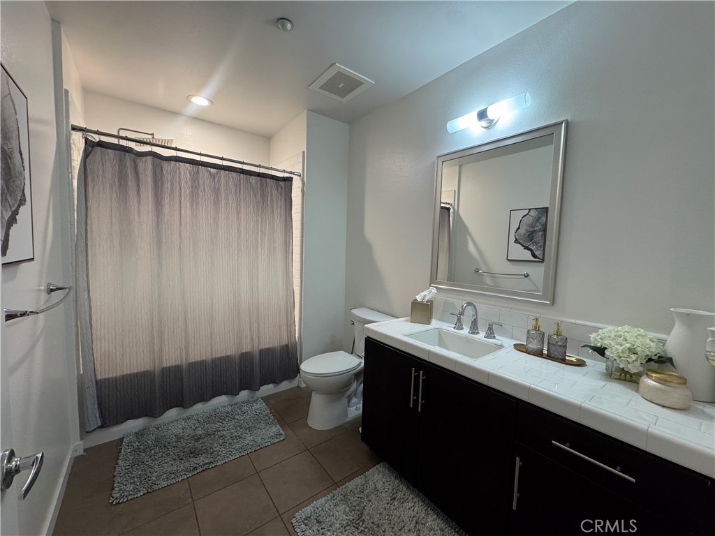 21 Gramercy, Unit 218 Irvine, CA 92612 - Photo 37 of 40 a bathroom with a sink and a mirror