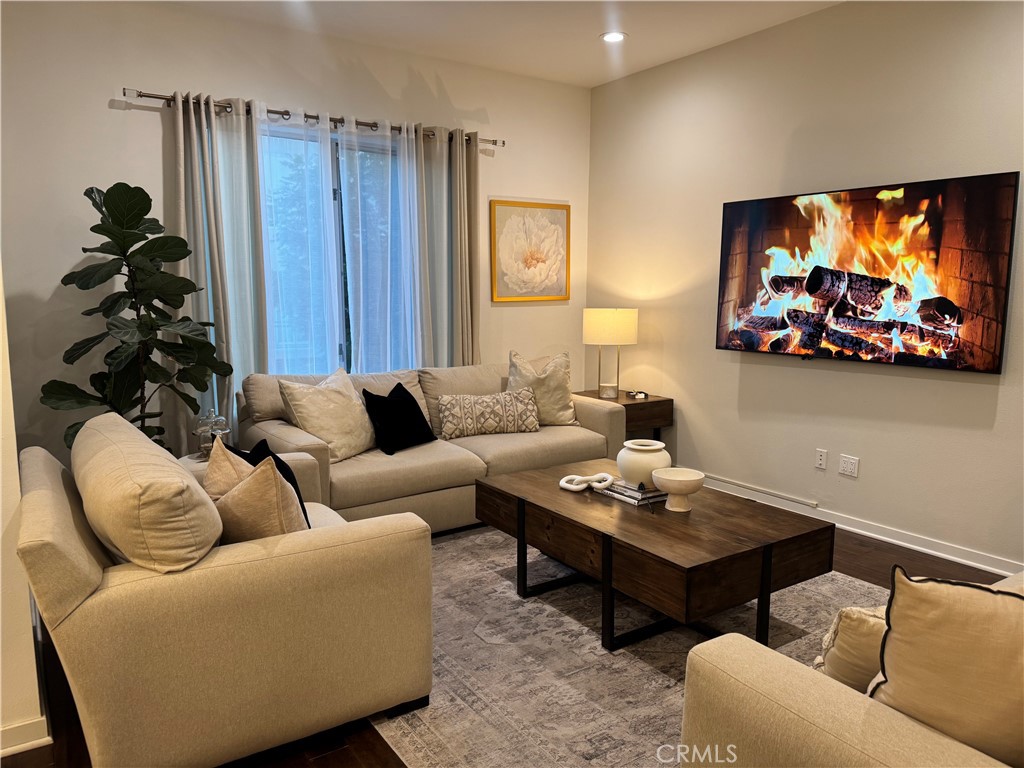 21 Gramercy, Unit 218 Irvine, CA 92612 - Photo 9 of 40 a living room with furniture and a flat screen tv