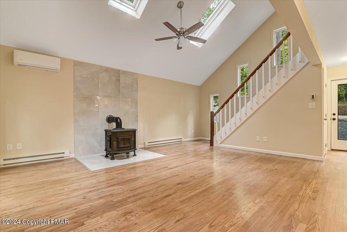 159 Manchester Drive Bushkill, PA 18324 - Photo 11 of 68 a view of an empty room with wooden floor and a ceiling fan