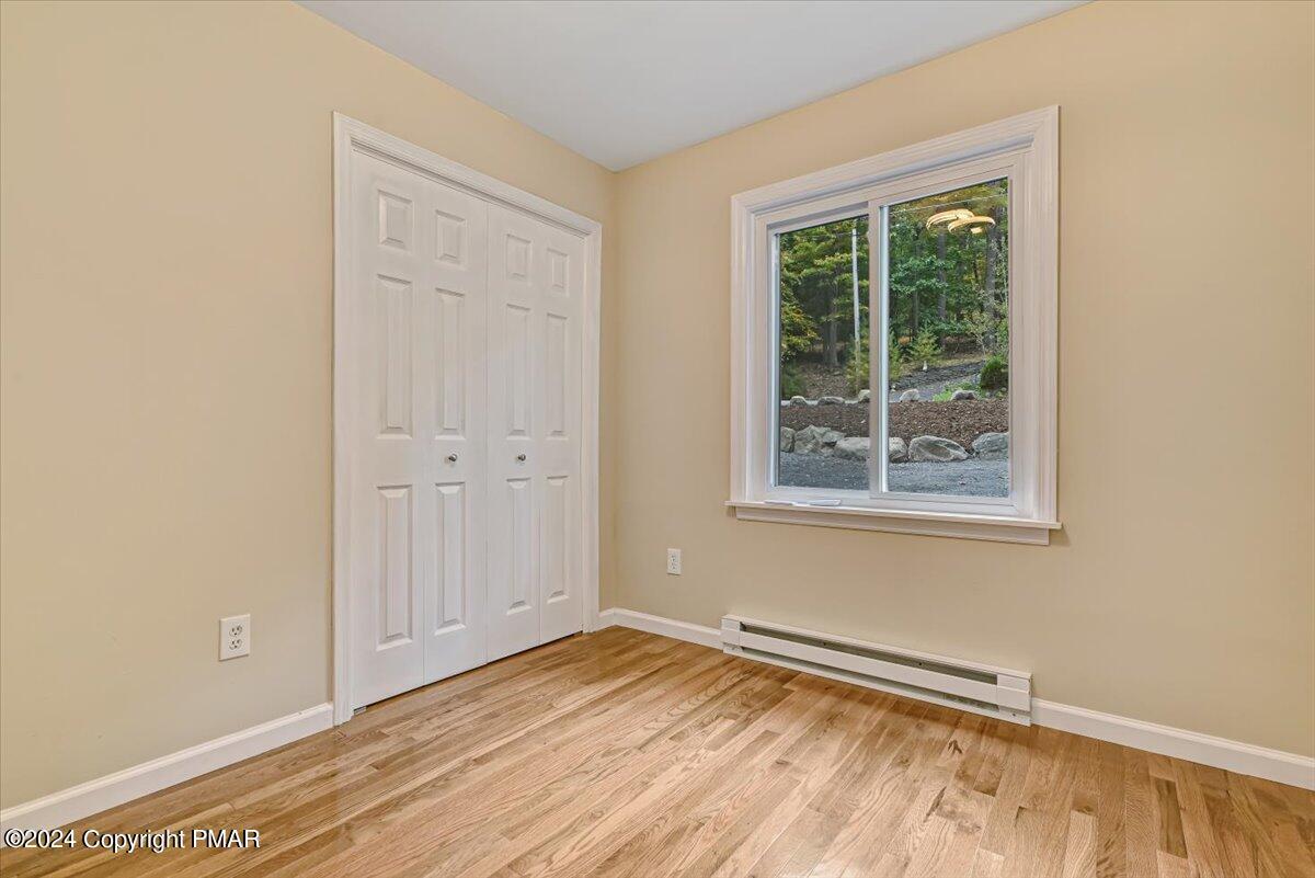 159 Manchester Drive Bushkill, PA 18324 - Photo 19 of 68 an empty room with wooden floor and windows