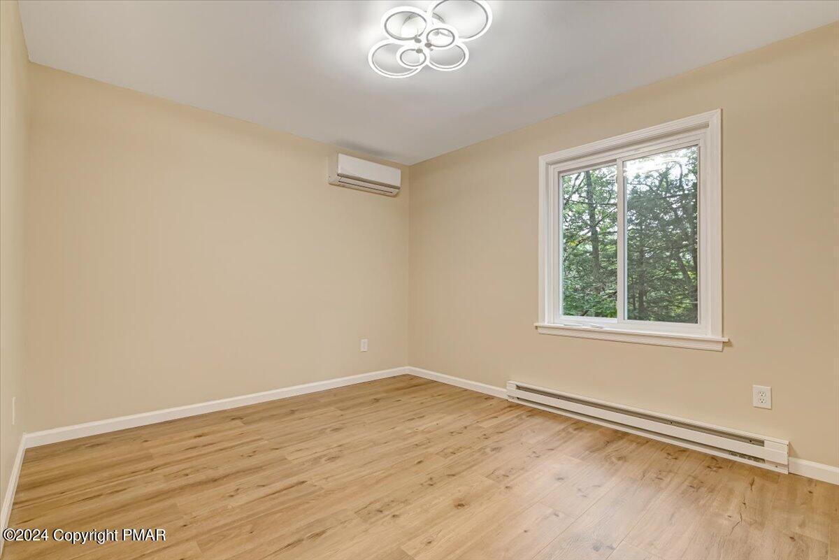 159 Manchester Drive Bushkill, PA 18324 - Photo 26 of 68 wooden floor in an empty room with a window