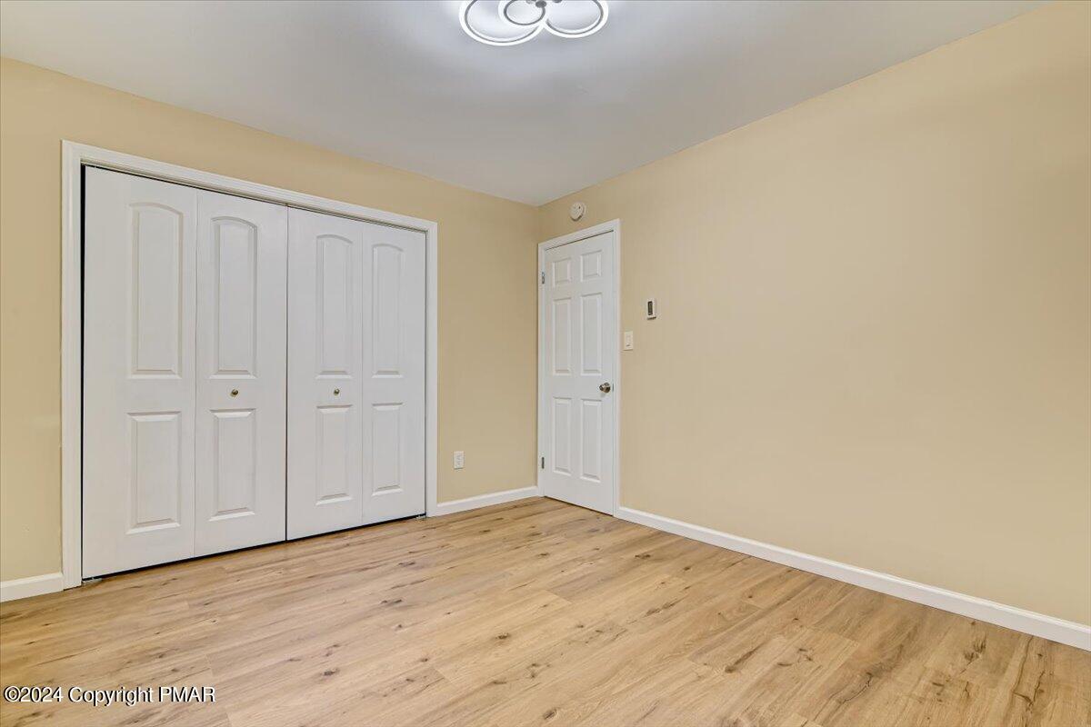 159 Manchester Drive Bushkill, PA 18324 - Photo 27 of 68 a view of an empty room with wooden floor
