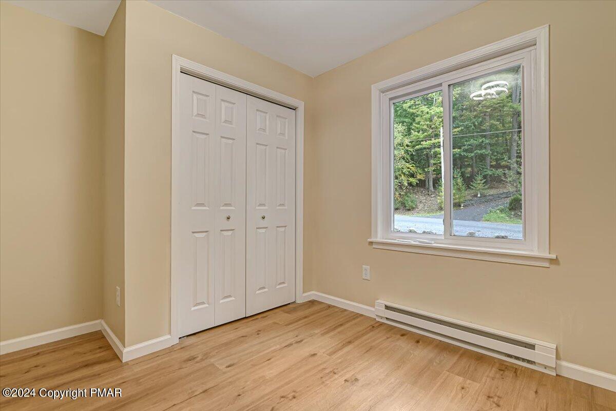 159 Manchester Drive Bushkill, PA 18324 - Photo 29 of 68 a view of an empty room with wooden floor and a window