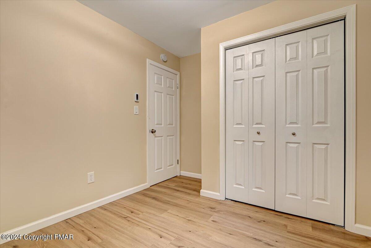 159 Manchester Drive Bushkill, PA 18324 - Photo 30 of 68 a view of an empty room with wooden floor