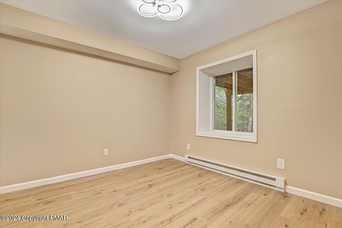 159 Manchester Drive Bushkill, PA 18324 - Photo 36 of 68 an empty room with wooden floor and windows