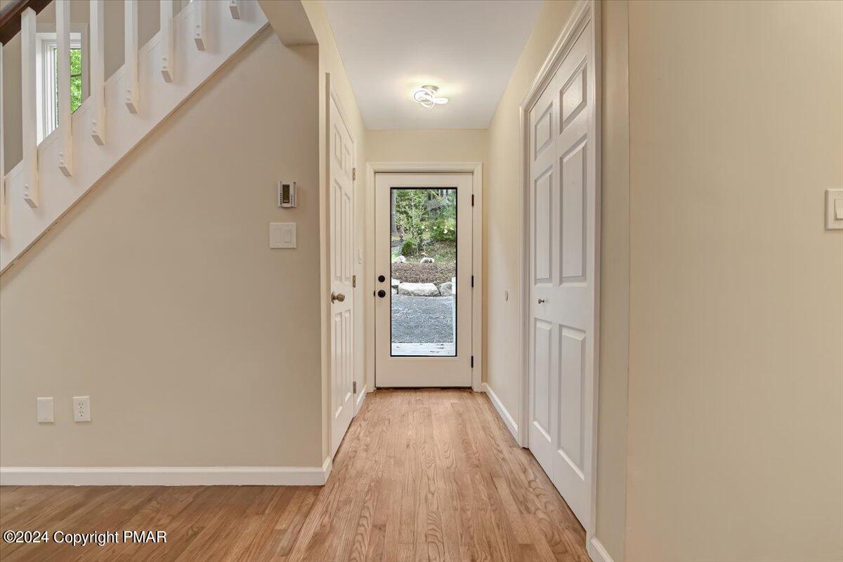 159 Manchester Drive Bushkill, PA 18324 - Photo 8 of 68 a view of a hallway with wooden floor and a bathroom