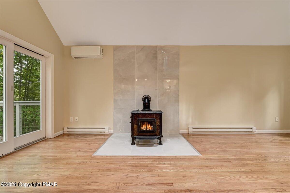 159 Manchester Drive Bushkill, PA 18324 - Photo 10 of 68 a living room with a fireplace furniture and a wooden floor