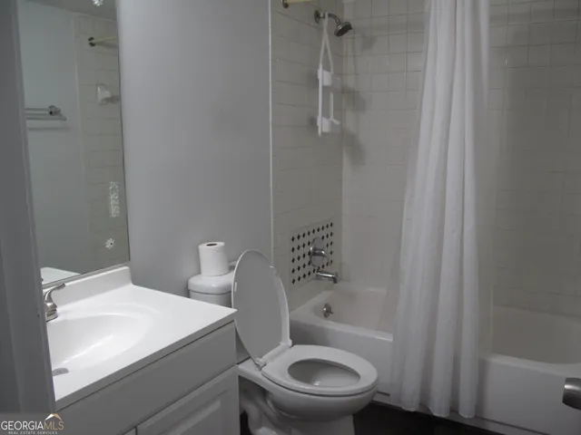 a white toilet sitting next to a bathroom sink