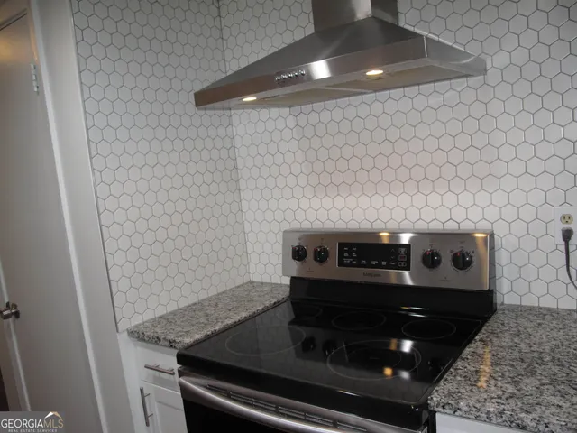a stove top oven sitting inside of a kitchen