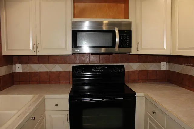 a kitchen with a stove and a microwave