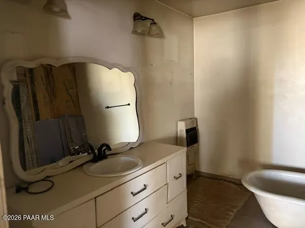 a bathroom with a sink and mirror