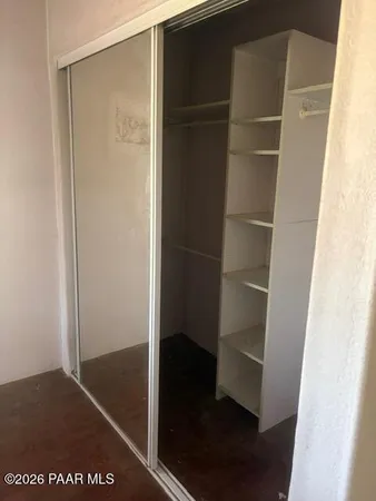 a view of walk in closet with empty racks