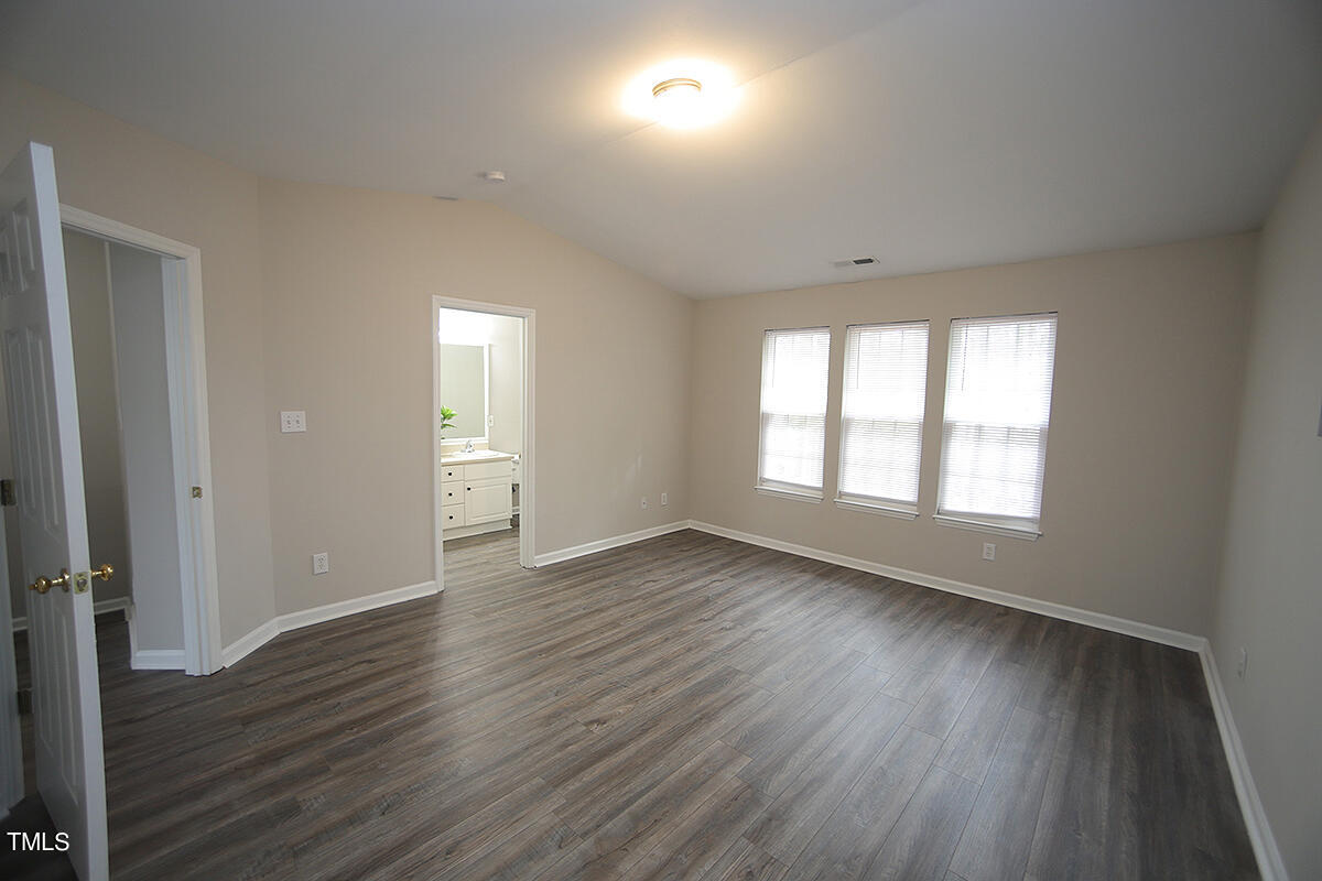 6012 San Marcos Way Raleigh, NC 27616 - Photo 11 of 17 an empty room with wooden floor and windows
