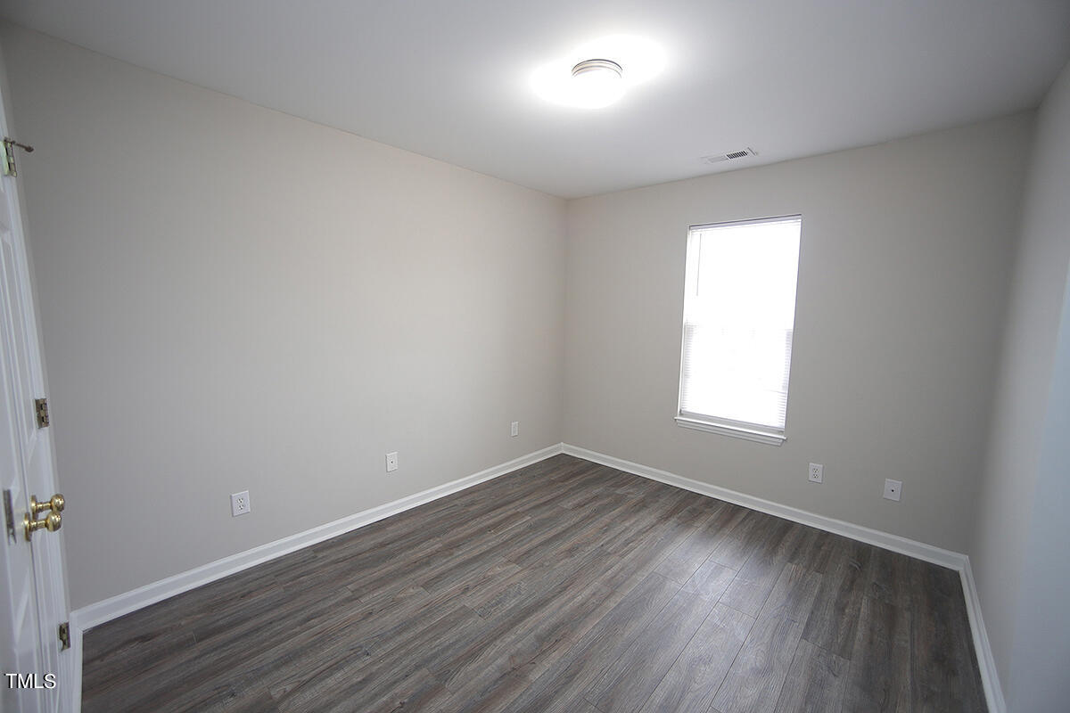 6012 San Marcos Way Raleigh, NC 27616 - Photo 13 of 17 an empty room with wooden floor and windows