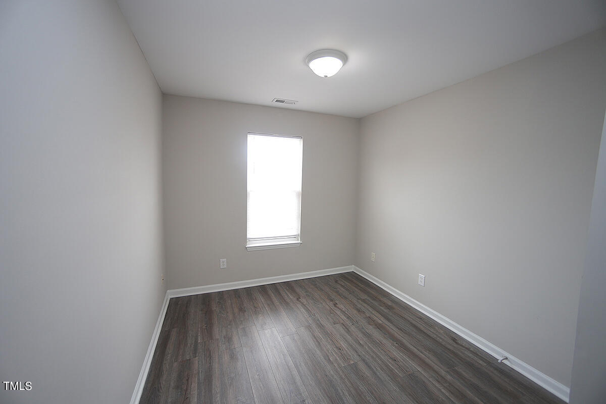 6012 San Marcos Way Raleigh, NC 27616 - Photo 14 of 17 an empty room with wooden floor and windows