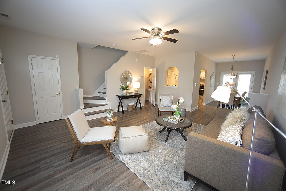 6012 San Marcos Way Raleigh, NC 27616 - Photo 4 of 17 a living room with couches a table and a potted plant with wooden floor