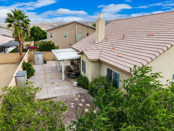 a aerial view of a house with a yard and potted plants
