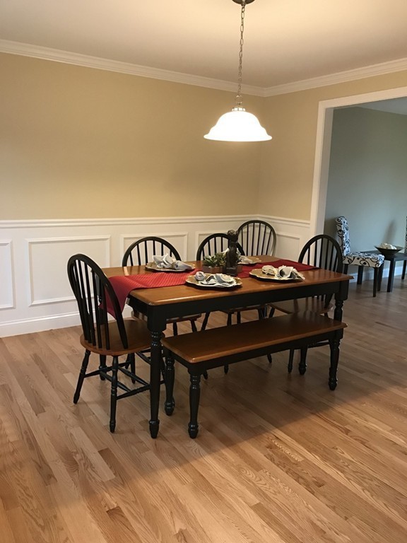 9 Reardon Road Billerica, MA 01821 - Photo 3 of 12 a view of a dining room with furniture wooden floor and chandelier