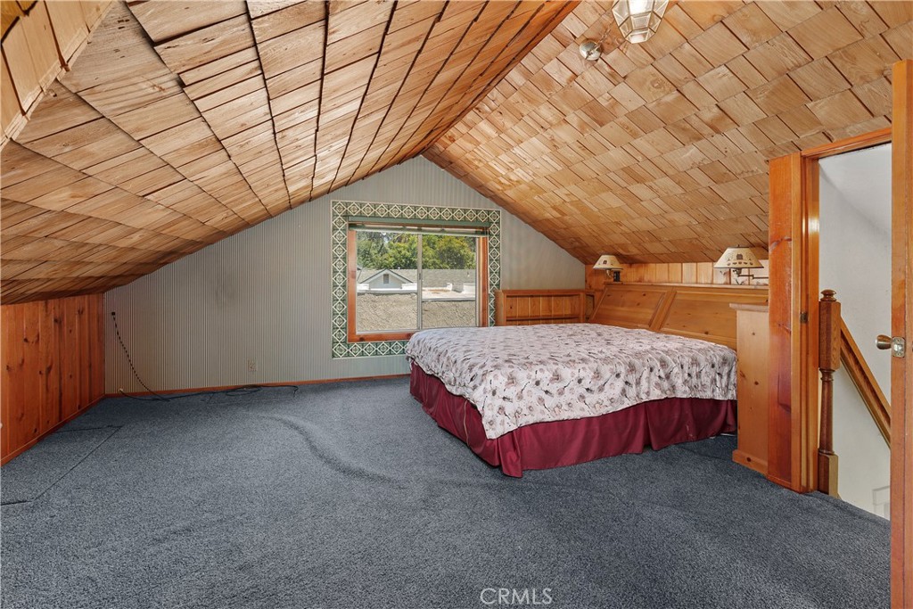 3892 Oakwood Place Riverside, CA 92506 - Photo 21 of 36 The expansive upstairs attic suite offers a truly unique retreat, featuring stunning vaulted ceilings clad in shingle and authentic tongue-and-groove wood paneling.