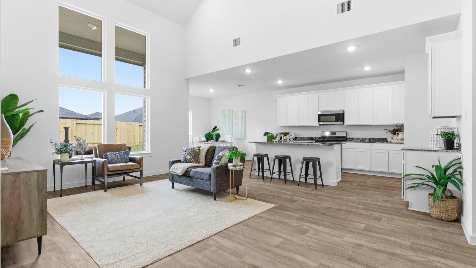 6311 Cherry Mdws Street Rosenberg, TX 77469 - Photo 9 of 43 a living room kitchen with furniture and a wooden floor