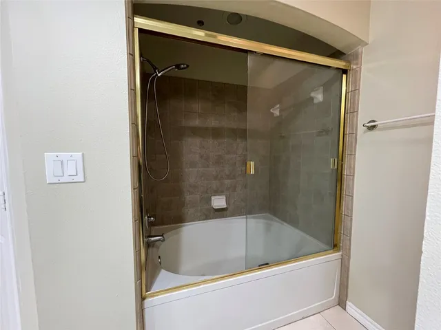 a bath tub sitting next to a shower