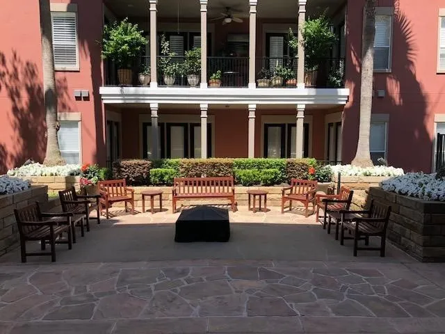 a view of a patio with table and chairs and potted plants