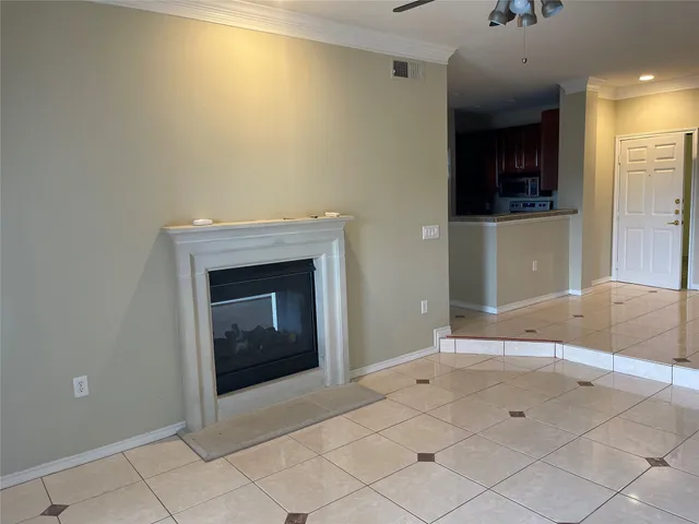 a view of an empty room and fire place