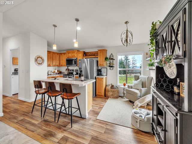 22575 Business 18 Willamina, OR 97396 - Photo 7 of 24 a kitchen with stainless steel appliances kitchen island granite countertop a refrigerator a stove a oven and white cabinets with wooden floors
