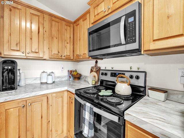 22575 Business 18 Willamina, OR 97396 - Photo 9 of 24 a kitchen with a stove and a microwave