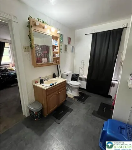 a bathroom with a toilet sink and mirror
