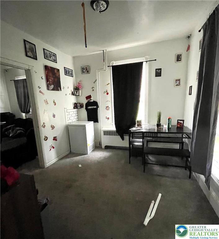 1239 4th Street Slatington, PA 18080 - Photo 3 of 17 a living room with furniture a flat screen tv and a refrigerator